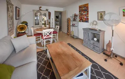 a living room with a couch and a table at Nice Apartment In L'isle-Sur-La-Sorgue in LʼIsle-sur-la-Sorgue