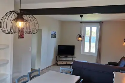 a living room with a blue couch and a tv at Camargu'Alpilles in Mollégès