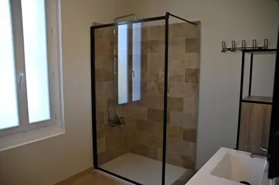 a shower with a glass door in a bathroom at Camargu'Alpilles in Mollégès