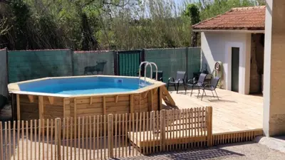a hot tub on a wooden deck with a fence at Camargu'Alpilles in Mollégès