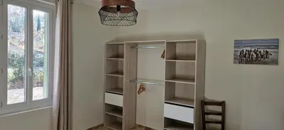 a walk in closet with shelves and a window at Camargu'Alpilles in Mollégès