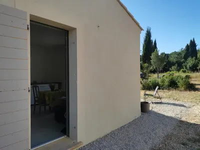 a building with a large window on the side of it at Logement au calme à LOURMARIN in Lourmarin