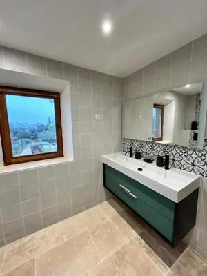 a bathroom with a sink and a mirror at Les Cachots in Roussillon