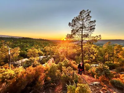 a person standing on a trail with a tree at Les Cachots in Roussillon