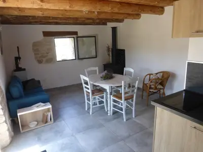 a kitchen and dining room with a table and chairs at Le grangeon des Hermas in Sault-de-Vaucluse