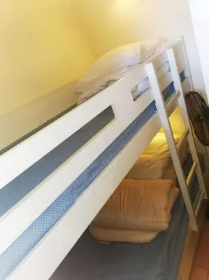 a bunk bed in a room with a ladder at Petit cocon en Provence in Mallemort