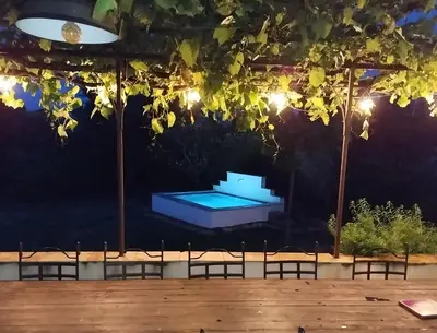 a swimming pool at night with lights at Villa face au Mont Ventoux avec bassin in Modène