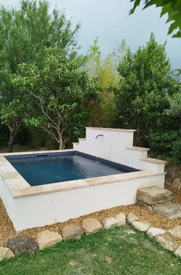 a swimming pool in a backyard with trees at Villa face au Mont Ventoux avec bassin in Modène