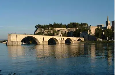 a bridge over a body of water with a city at Villa face au Mont Ventoux avec bassin in Modène