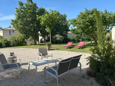 a group of chairs sitting in a yard at Maison avec jardin in Saumane-de-Vaucluse