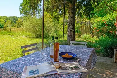 a table with a book and a plate of food on it at Mas de l'Aube in Mouriès