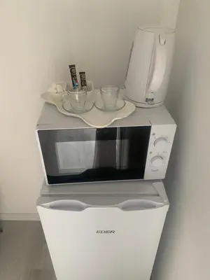 a microwave with two cups on top of it at Suite avec sauna in Pertuis