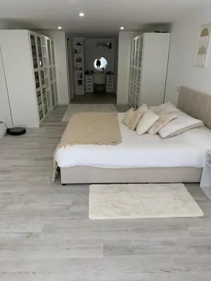 a large bedroom with a large bed and a rug at Suite avec sauna in Pertuis