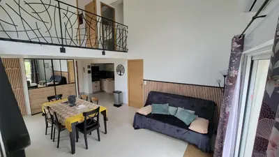 a living room with a couch and a table at Le PEROTIN in Villes-sur-Auzon