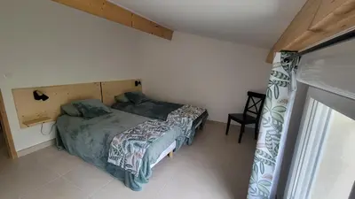 a small bedroom with a bed and a window at Le PEROTIN in Villes-sur-Auzon