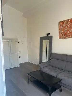 a living room with a couch and a coffee table at Le Loft de Roxane Centre historique Aix en Provence in Aix-en-Provence