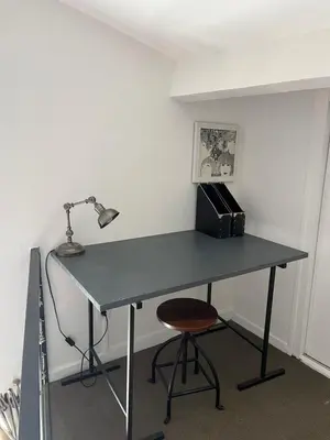 a desk with a lamp and a chair in a room at Le Loft de Roxane Centre historique Aix en Provence in Aix-en-Provence