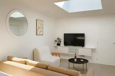 a living room with a couch and a tv at Maison moderne jardin piscine et parking prives, près d'Aix Centre in Venelles