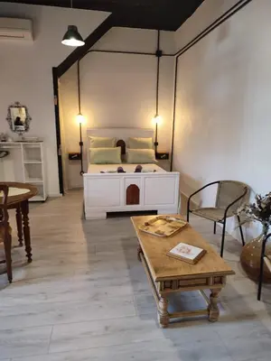 a room with a bed and a table and chairs at Les Oliviers in Caumont-sur-Durance