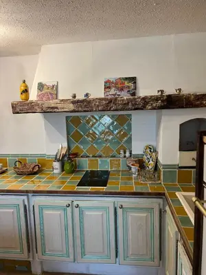 a kitchen with a sink and a tiled counter top at Chez Dragos centre ville Lauris in Lauris