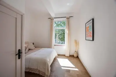 a bedroom with a bed and a window at La Suite Provençale in Aix-en-Provence