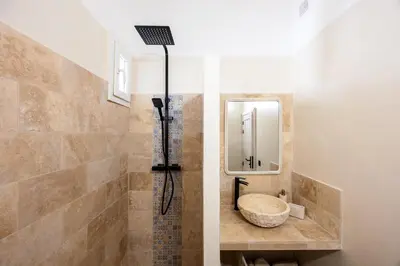 a bathroom with a sink and a shower at La Suite Provençale in Aix-en-Provence