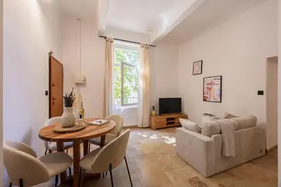 a living room with a table and a couch at La Suite Provençale in Aix-en-Provence