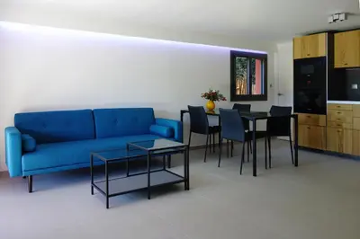 a living room with a blue couch and a table at Madehouse - T3 indépendant-Piscine-Centre ville Aix à pied-Stationnement gratuit dans la rue in Aix-en-Provence