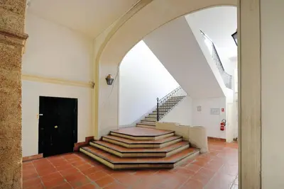 a staircase in a building with a stair case at La Rotonde - Magnifique Appartement climatisé avec parking in Aix-en-Provence