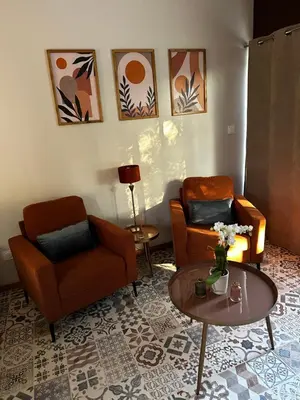a living room with two chairs and a table at La Provence in Maubec