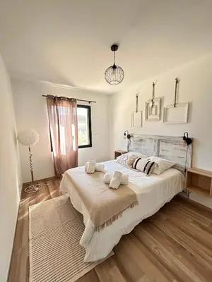 a bedroom with a large bed with two pillows on it at Villa en Provence avec piscine in Mollégès