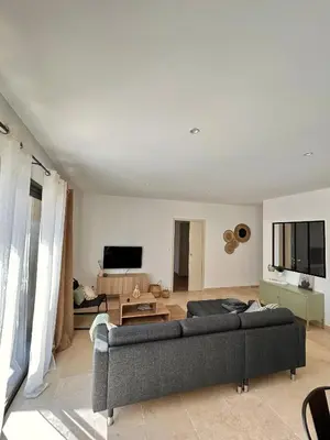 a living room with a couch and a tv at Villa en Provence avec piscine in Mollégès
