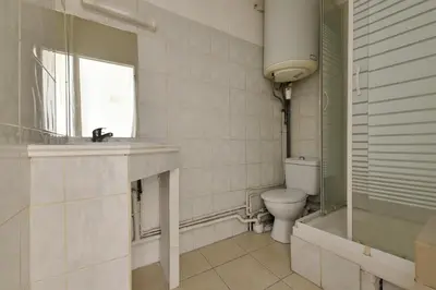 a bathroom with a toilet and a sink and a shower at Studio Lavande in La Fare-les-Oliviers