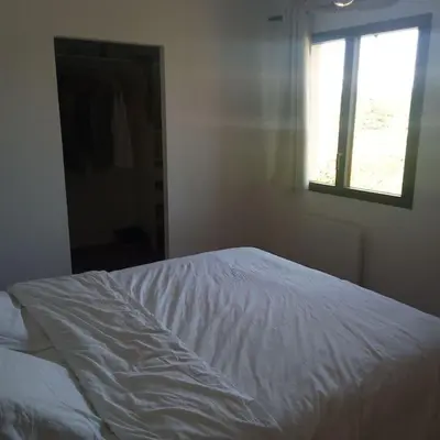 a white bed in a bedroom with a window at Bastide 3 chambres 6personnes avec piscine sur Aix en Provence in Aix-en-Provence