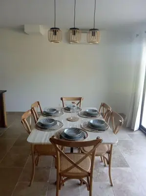 a dining room table with chairs and plates on it at Bastide 3 chambres 6personnes avec piscine sur Aix en Provence in Aix-en-Provence