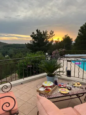 a tray of food on a table on a balcony at Villa BELVENTO, superbe villa au calme, piscine, vue incroyable ! in Ventabren
