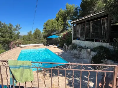 a swimming pool in a yard with a fence at Villa BELVENTO, superbe villa au calme, piscine, vue incroyable ! in Ventabren
