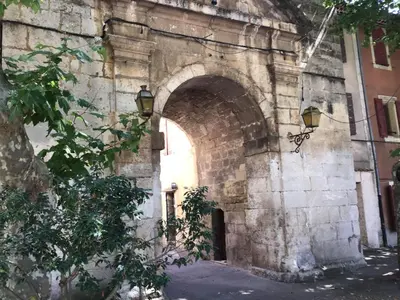 an archway in an old stone building with a door at Pretty, spacious holiday home with private pool in Villes-sur-Auzon