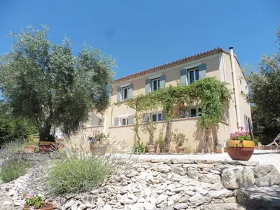 a living room with a couch and a tv at Pretty, spacious holiday home with private pool in Villes-sur-Auzon