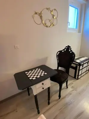 a room with a table and a chair with a chessboard on it at Calussine maison provençale in Pernes-les-Fontaines