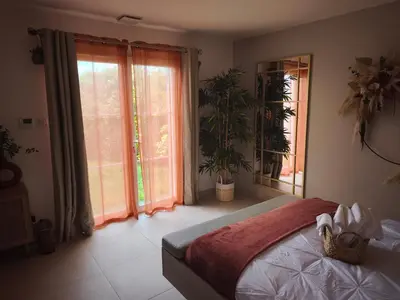 a bedroom with a bed and a large window at Chambre chez l'habitant à Pernes les Fontaines in Pernes-les-Fontaines