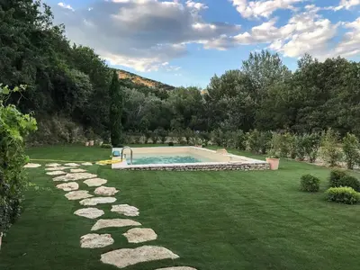 a swimming pool in the middle of a yard at La Bergerie de Chateau Fontvert in Lourmarin