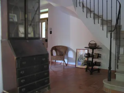 a staircase with a dresser and a chair in a room at La Maison Cassée in Malemort-du-Comtat