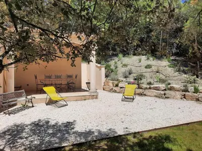 two yellow chairs and a table in a yard at Maison de vacances avec piscine privative, Oustau des Oliviers vue dominante Colorado provençal in Rustrel