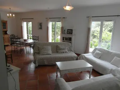 a living room with two couches and a table at Maison de vacances avec piscine privative, Oustau des Oliviers vue dominante Colorado provençal in Rustrel