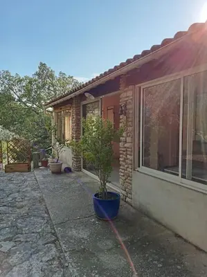 a potted plant sitting outside of a house at La garenne basse chez Sylvie in Saint-Didier