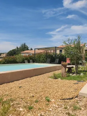 a swimming pool with a bench and a table at Gite l'épinette in Saint-Saturnin-les-Apt