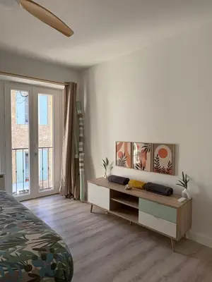 a bedroom with a bed and a dresser and a window at Le Nid Provençal in Lambesc