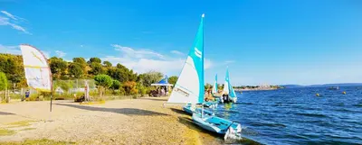 a small sail boat on the shore of a lake at Appartement dans mas avec piscine privée sans vis a vis in Miramas