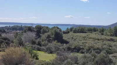 a view from the top of a hill with trees and water at Appartement dans mas avec piscine privée sans vis a vis in Miramas